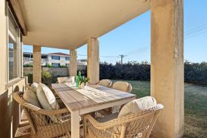 a table and chairs on a porch with a view of the ocean at Pet-Friendly Beachfront Family Dog Bch in Mandurah