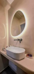 a bathroom with a white sink and a mirror at Volca Studios in Emporio