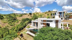 an aerial view of a house on a hill at Villa Sambirano - avec piscine et vue mer - Nosy Be in Saint-Denis