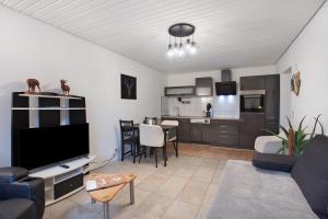 a living room with a couch and a kitchen at Ferreira's Ferienwohnung in St. Blasien