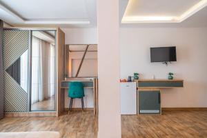 a room with a chair and a desk and a tv at Vila Kollari in Ulcinj