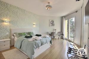 a bedroom with a bed with towels on it at La rose des vents in La Chèze +54 photos