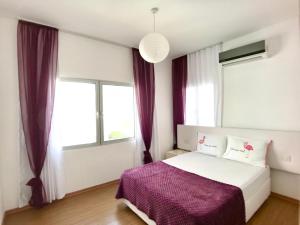Ένα ή περισσότερα κρεβάτια σε δωμάτιο στο RIX Apartments in Girne +55 φωτογραφίες