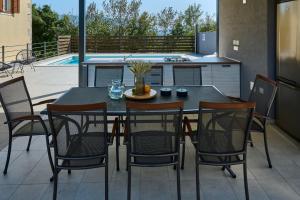 a table and chairs sitting on a patio at Villa Telma in Kostrčani - Haus für 8-10 Personen in Kostrčani +32 photos