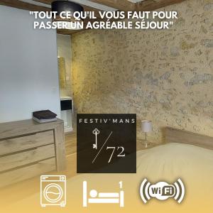 a sign in a room with a bed and a table at Festiv'Mans72 - Le Four à pain - Parking - Wifi - Circuit des 24h du Mans à 7 min in Mulsanne