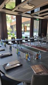 ein langer Tisch in einem Raum mit Tischen und Stühlen in der Unterkunft Lipa Hotel in Travnik