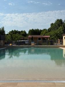 a swimming pool with blue water at Camping Bungalow el Llac de Banyoles in Porqueres