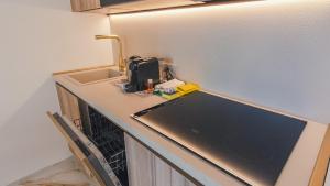 a kitchen counter with a sink and a sewing machine on it at Suite Sirmione Studio - Italian Homing in Sirmione