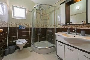 a bathroom with a shower and a sink and a toilet at Mavi Melodi Suite in Fethiye +9 photos