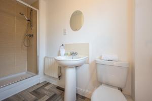 a bathroom with a toilet and a sink and a shower at Atlanta's Residence by Tŷ SA in Newport