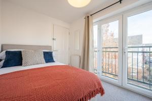 a bedroom with a bed and a large window at Atlanta's Residence by Tŷ SA in Newport