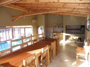 a dining room with a large wooden table and chairs at Departamento Cerro Catedral in San Carlos de Bariloche