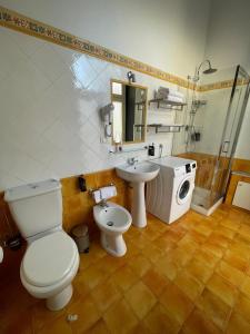 a bathroom with a toilet and a sink and a shower at Miralong House in Catania +11 photos