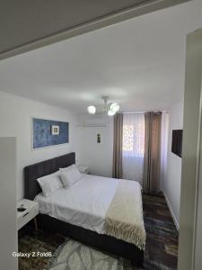 a bedroom with a large bed and a window at David & Matei Residence in Jurilovca