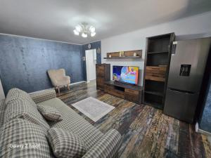 a living room with a couch and a tv at David & Matei Residence in Jurilovca