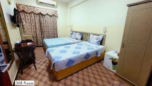 Postel nebo postele na pokoji v ubytování Al Arraf Hotel
