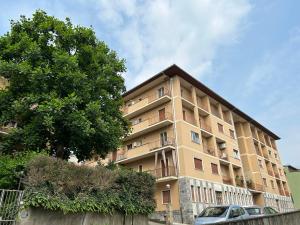 a tall building with a car parked in front of it at Casa Rosy by Holiday World in Ivrea