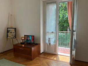 a room with a wooden table and a door with a window at Casa Rosy by Holiday World in Ivrea
