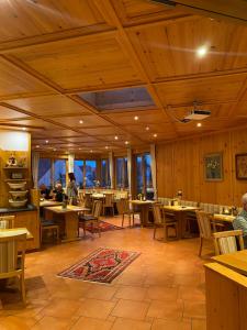 a restaurant with tables and chairs and people sitting at tables at Hotel Weyh in Pressath