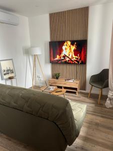 a living room with a couch and a fireplace at L Escapade Saint Laurent - Chalon sur Saône in Chalon-sur-Saône