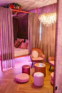 a living room with a bed and a couch and tables at Story Rooms in Olomouc