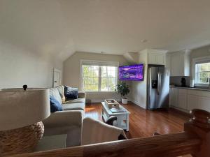 a living room with a couch and a refrigerator at Serenity in White Stone