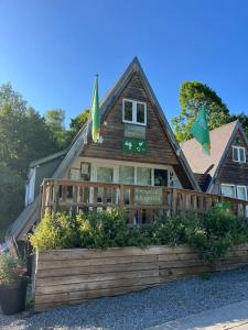a house with two flags on top of it at La Cachette De Durbuy - Chalet 203 in Durbuy