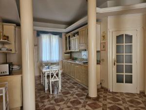 a kitchen with columns and a table in it at Luna Domus in Ozieri +8 photos