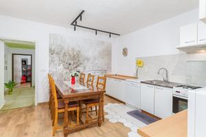 a kitchen with a table and chairs in a room at Holiday home Dioniza in Gajana