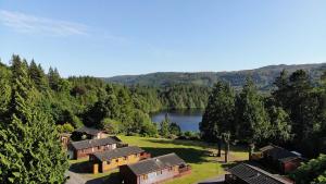 an aerial view of a resort with a lake and trees at Faskally Woods Holiday Park in Pitlochry +13 photos