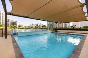 a swimming pool on the roof of a building at Stylish 1BR Warm & Curated Interiors in Dubai