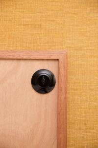 a door with a black door knocker on it at Hôtel Henri IV in La Rochelle