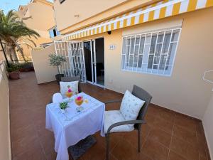 a table and two chairs on a patio with a table and chairs at Sunny Apartment Loma de Arguineguín in Arguineguín