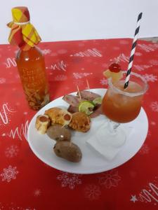 a plate of food and a drink on a table at Embruns 2 in Le Moule