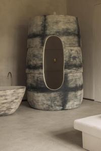 a large barrel sitting next to a bathroom with a tub at Jonojé Luxury Suites in Bruges +69 photos