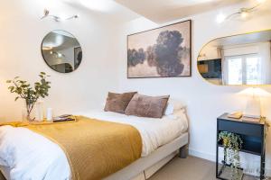 a bedroom with a bed and a mirror on the wall at Studio in heart of Paris in Paris