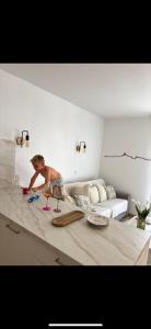 a young boy standing on a counter in a living room at Magnifique appartement lumineux avec piscine in Mallemort