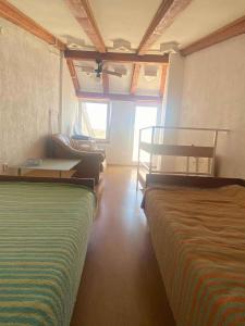 a bedroom with two beds and a table and a couch at Holiday home in Novi Vinodolski 15408 in Novi Vinodolski