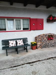 a bench sitting in front of a building with flowers at Casa Simion in Mezzano