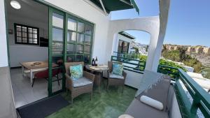 a balcony with a table and chairs on a balcony at Golden Views Apartment in San Bartolomé