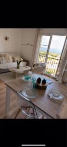 a living room with a table and a large window at Magnifique appartement lumineux avec piscine in Mallemort