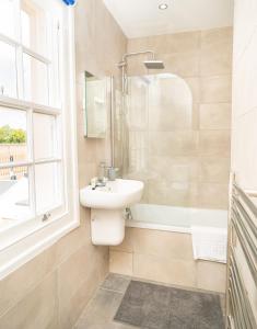 a bathroom with a sink and a shower at The Residence by Guestz in Cheltenham +21 photos
