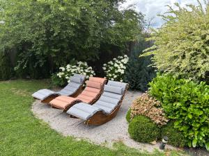 a group of chairs sitting in a garden at Family Tree rekreačný dom in Liptovský Mikuláš