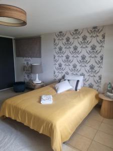 a bedroom with a bed with two towels on it at Brive, La Villa Bellevue in Buissou +6 photos
