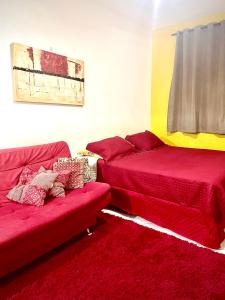 a living room with two beds and a couch at Kitinete com ótima localização in Santos