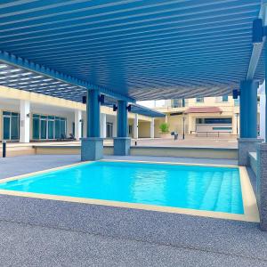 a swimming pool in front of a building at Cozy City, Large studio stay for couple or family , Riverine Diamond in Kuching