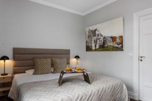 a bedroom with a bed with a table on it at Berg Apartments in Reykjavík