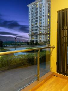 a balcony with a view of a building at Cozy City, Large studio stay for couple or family , Riverine Diamond in Kuching