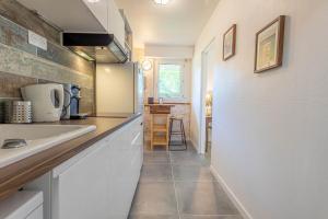 a kitchen with a sink and a counter top at Le Mérignac Cozy Corner - T3 & Terrasse in Mérignac