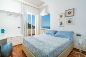 a bedroom with a bed and a large window at Luxury Levaina Villa Sleeps 8 on the Amalfi Coast in Positano +38 photos